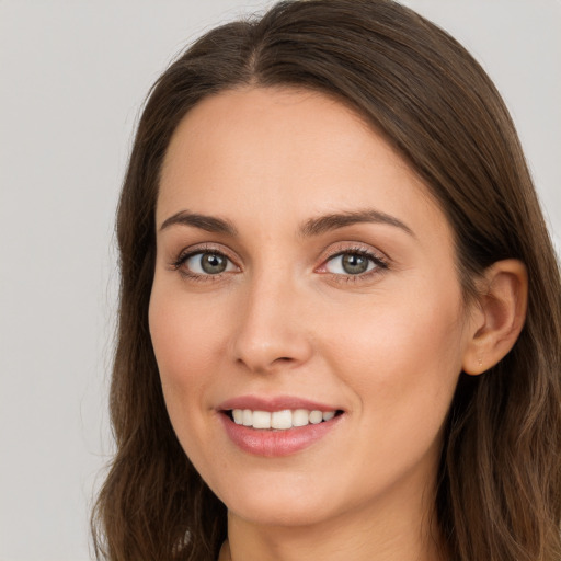 Joyful white young-adult female with long  brown hair and brown eyes