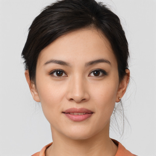 Joyful asian young-adult female with medium  brown hair and brown eyes