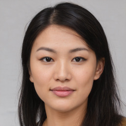 Joyful asian young-adult female with long  brown hair and brown eyes