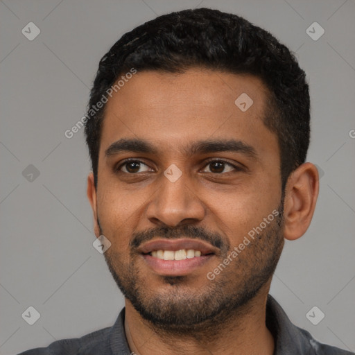 Joyful black young-adult male with short  black hair and brown eyes