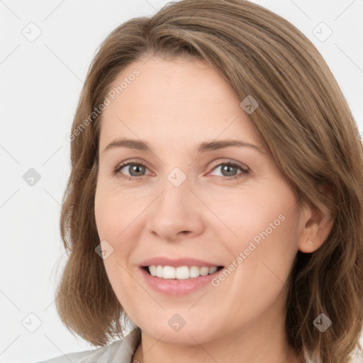 Joyful white young-adult female with medium  brown hair and grey eyes