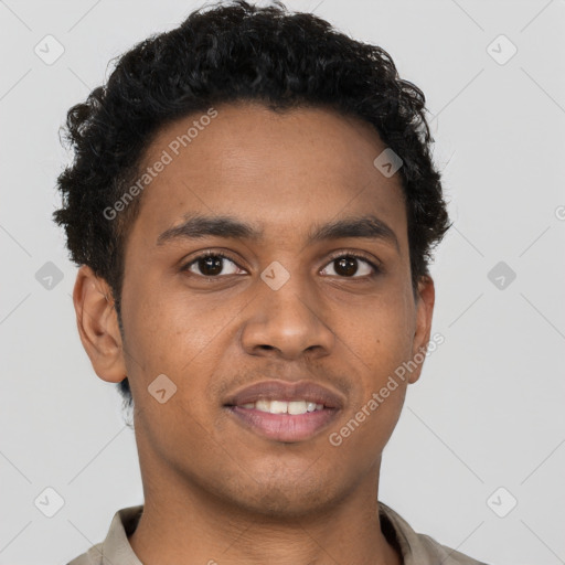 Joyful black young-adult male with short  brown hair and brown eyes