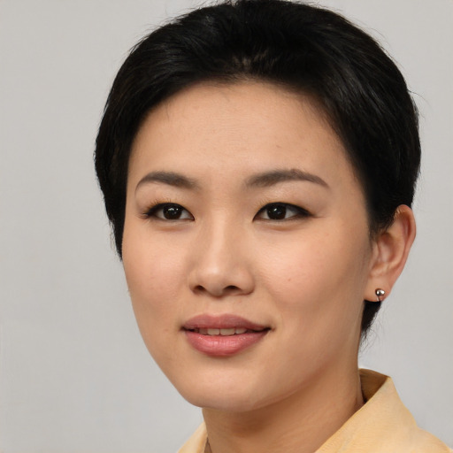 Joyful asian young-adult female with short  black hair and brown eyes