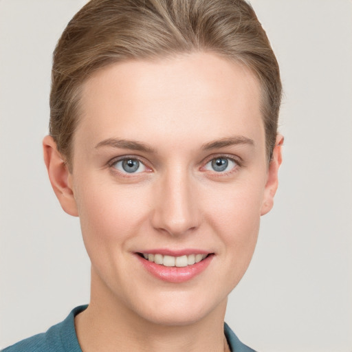 Joyful white young-adult female with short  brown hair and grey eyes