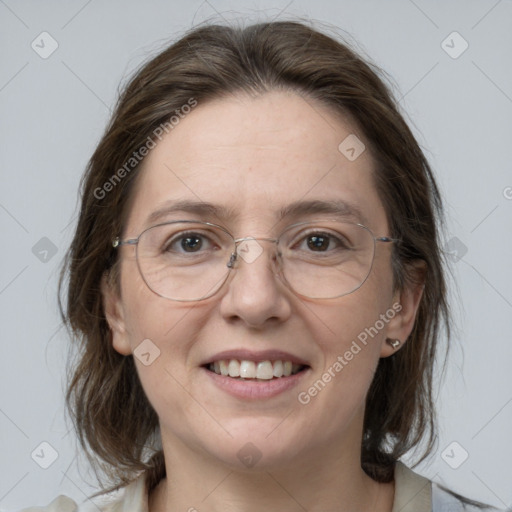 Joyful white adult female with medium  brown hair and grey eyes