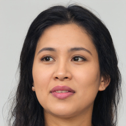 Joyful asian young-adult female with long  black hair and brown eyes