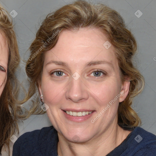 Joyful white adult female with medium  brown hair and blue eyes