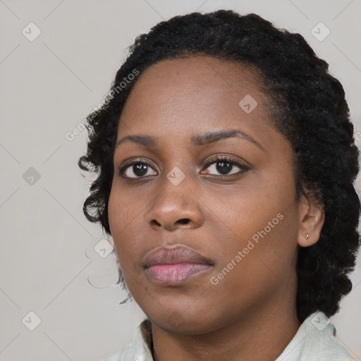 Joyful black young-adult female with medium  black hair and brown eyes