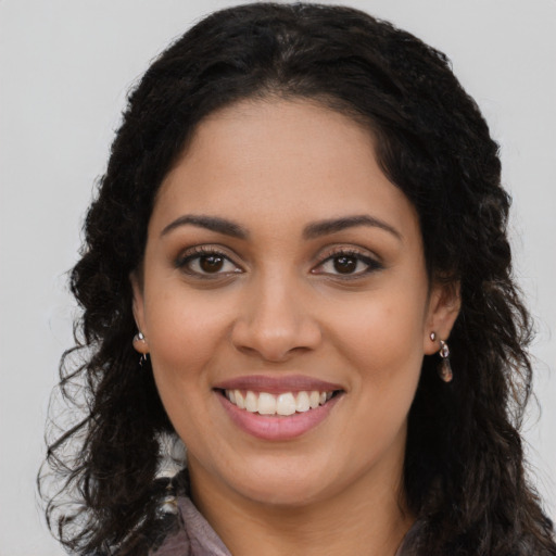 Joyful latino young-adult female with long  brown hair and brown eyes