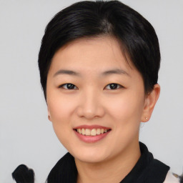 Joyful asian young-adult female with short  black hair and brown eyes