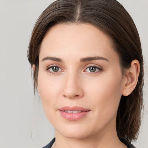 Joyful white young-adult female with medium  brown hair and brown eyes