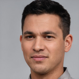 Joyful white young-adult male with short  black hair and brown eyes