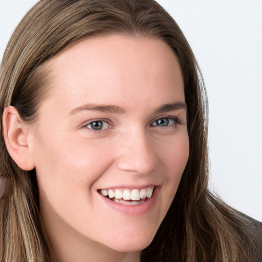 Joyful white young-adult female with long  brown hair and blue eyes