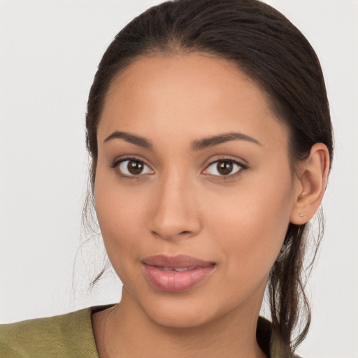 Joyful latino young-adult female with long  brown hair and brown eyes