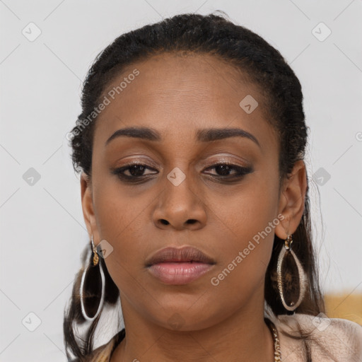 Joyful black young-adult female with long  brown hair and brown eyes