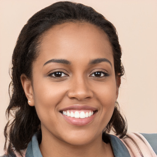 Joyful latino young-adult female with long  brown hair and brown eyes