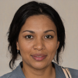 Joyful black adult female with medium  brown hair and brown eyes