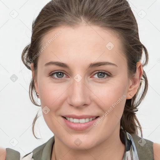 Joyful white young-adult female with medium  brown hair and grey eyes