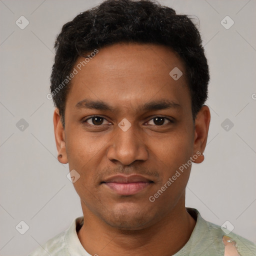 Joyful black young-adult male with short  black hair and brown eyes