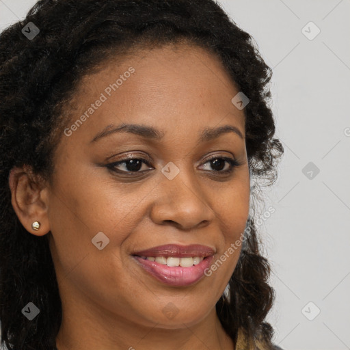 Joyful black young-adult female with long  brown hair and brown eyes