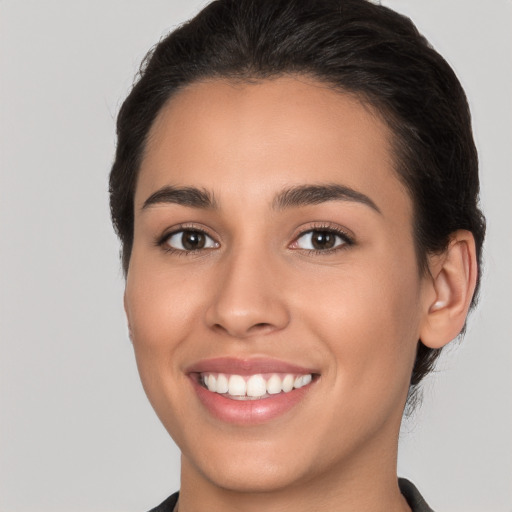 Joyful white young-adult female with medium  brown hair and brown eyes