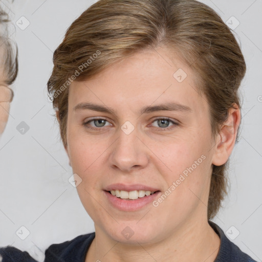 Joyful white young-adult female with medium  brown hair and grey eyes