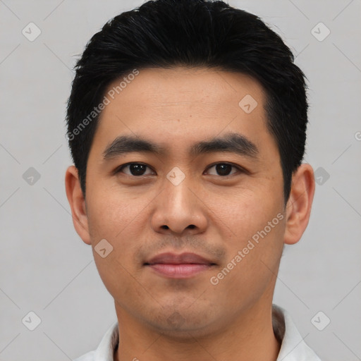 Joyful asian young-adult male with short  black hair and brown eyes