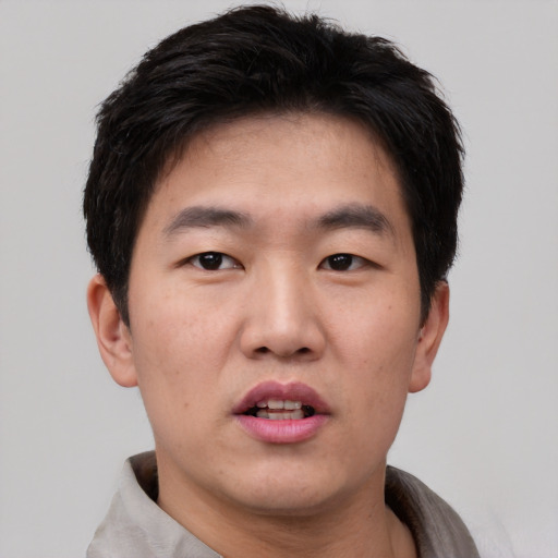 Neutral asian young-adult male with short  brown hair and brown eyes