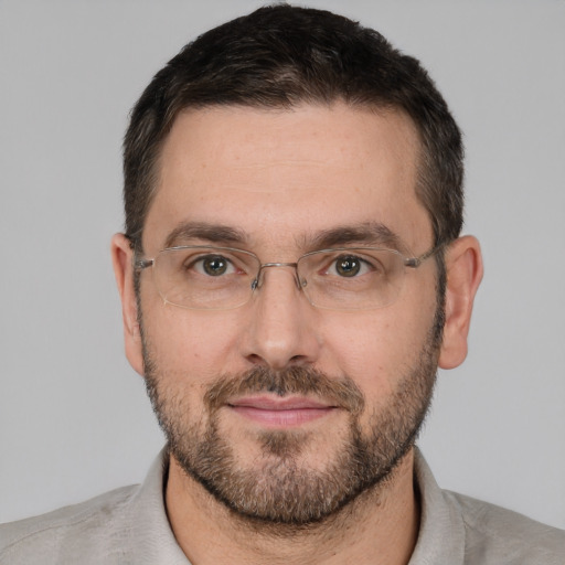 Joyful white adult male with short  brown hair and brown eyes