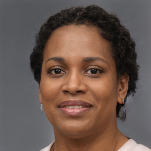 Joyful black adult female with short  brown hair and brown eyes