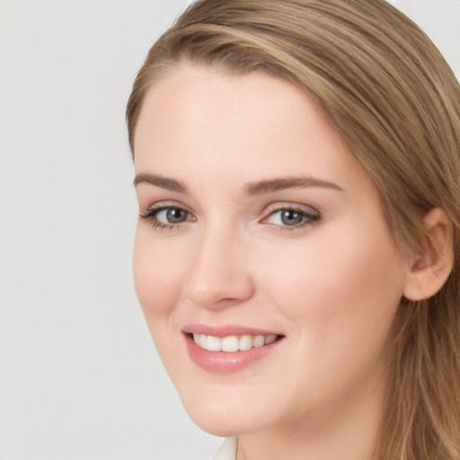 Joyful white young-adult female with long  brown hair and grey eyes