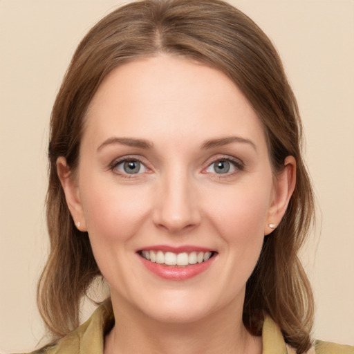 Joyful white young-adult female with medium  brown hair and green eyes