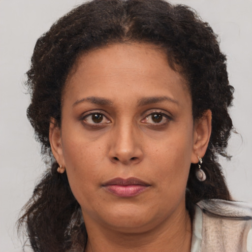Neutral black adult female with long  brown hair and brown eyes