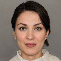 Joyful white adult female with medium  brown hair and brown eyes