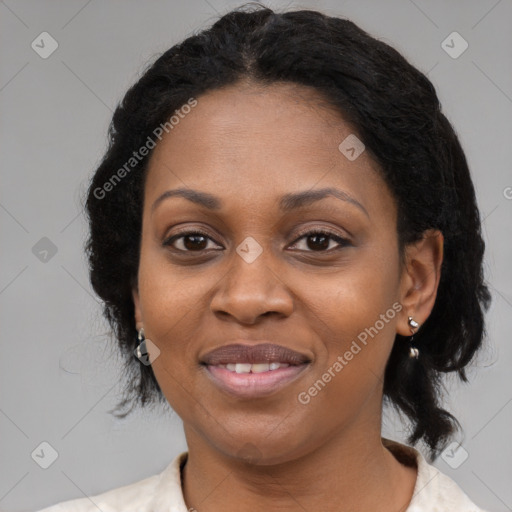 Joyful black adult female with medium  black hair and brown eyes