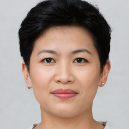 Joyful asian young-adult female with short  black hair and brown eyes