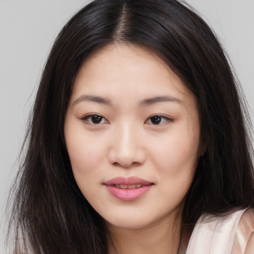 Joyful asian young-adult female with long  brown hair and brown eyes
