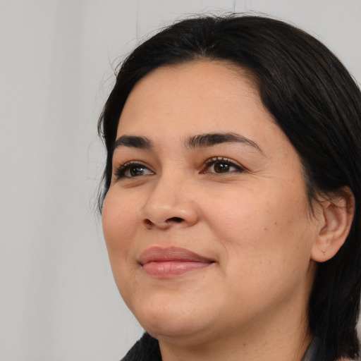 Joyful white young-adult female with medium  black hair and brown eyes