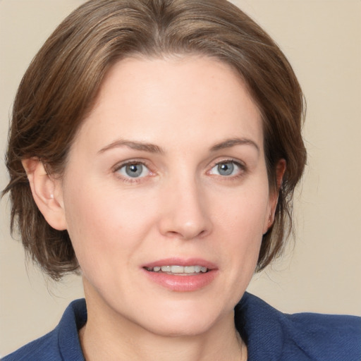 Joyful white young-adult female with medium  brown hair and grey eyes