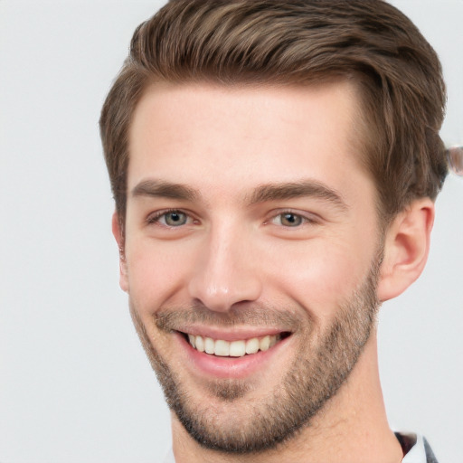 Joyful white young-adult male with short  brown hair and grey eyes