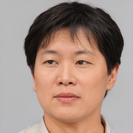 Joyful asian adult female with short  brown hair and brown eyes