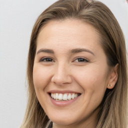 Joyful white young-adult female with long  brown hair and brown eyes