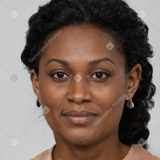 Joyful black adult female with short  brown hair and brown eyes