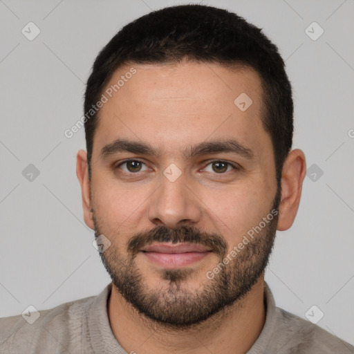 Joyful white young-adult male with short  brown hair and brown eyes