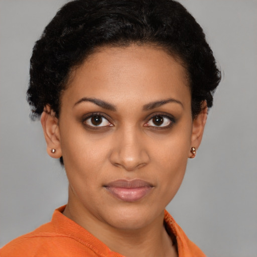 Joyful latino young-adult female with short  black hair and brown eyes
