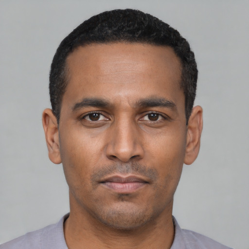 Neutral latino young-adult male with short  black hair and brown eyes