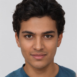 Joyful latino young-adult male with short  brown hair and brown eyes