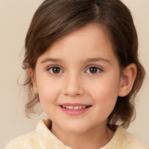 Joyful white child female with medium  brown hair and brown eyes