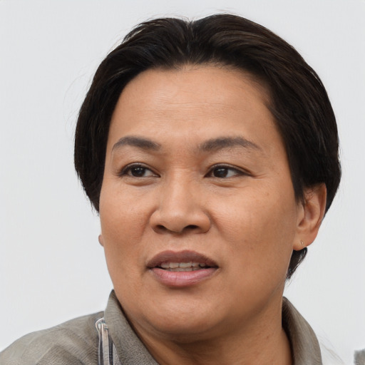 Joyful asian adult female with short  brown hair and brown eyes