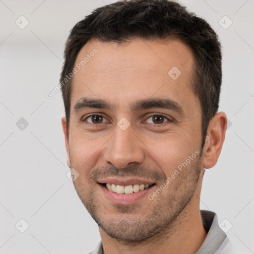 Joyful white young-adult male with short  brown hair and brown eyes